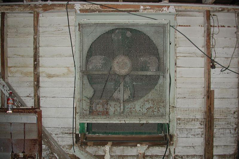 Water-damaged basement fan and wet flooring
