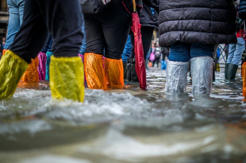 People in waterproof boots working in flood conditions